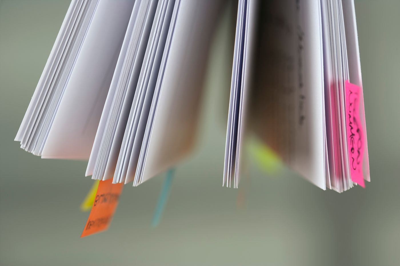 Printed source material organized with color-coded tabs